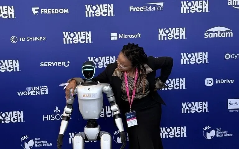 BUI's humanoid robot alongside a delegate at the Women in Tech Global Summit in Cape Town
